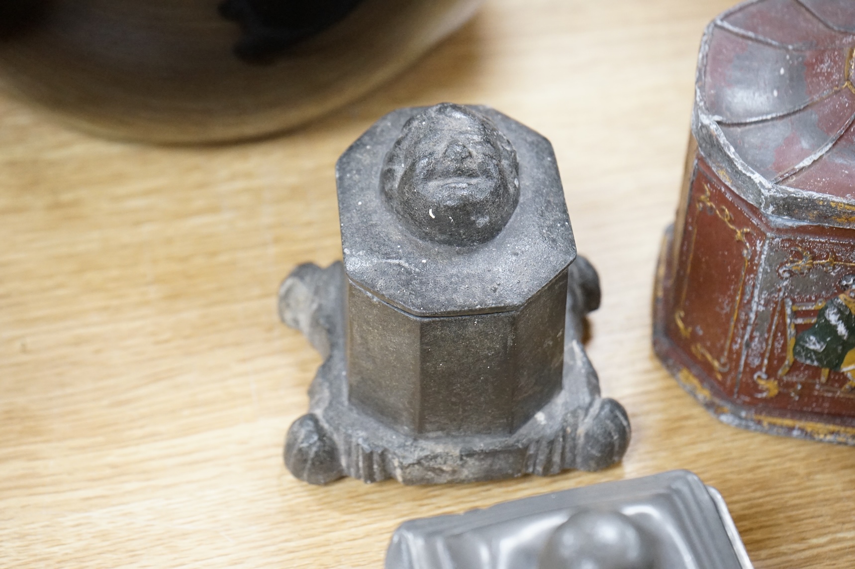 A collection of ten early 19th century lead tobacco boxes, to include an octagonal example, decorated in relief with the remains of red and gilt paint, largest 13cm wide